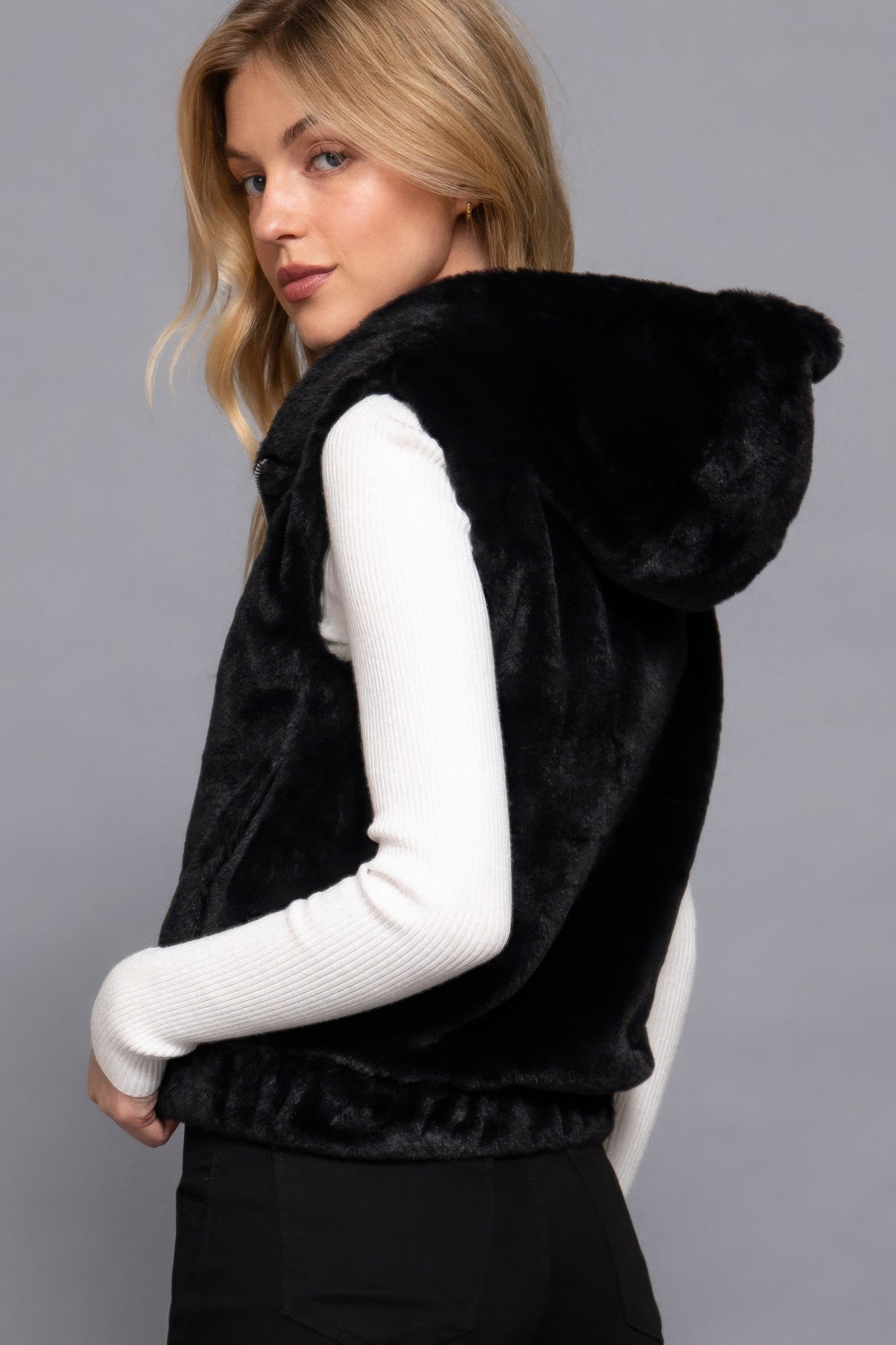 The Rory is our hooded faux fur vest that is perfect for Autumn and Winter. Ideal for layering over your favourite tops or sweaters. Perfect for casual outings on chilly days and as a stylish addition to your everyday wear. Fabric: 100% Polyester; faux fur. Colour: black.