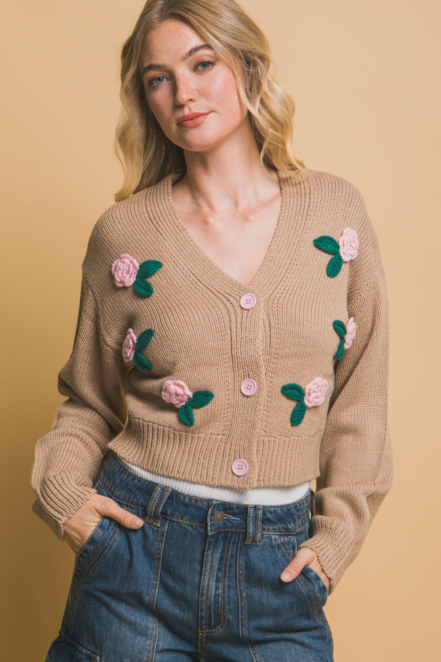 The Liya is a mid-cropped cardigan with charming flower details. Ideal for layering over dresses, blouses, or tees. Perfect for casual outings, work, or social events. Made from 100% acrylic. Colour: Khaki.