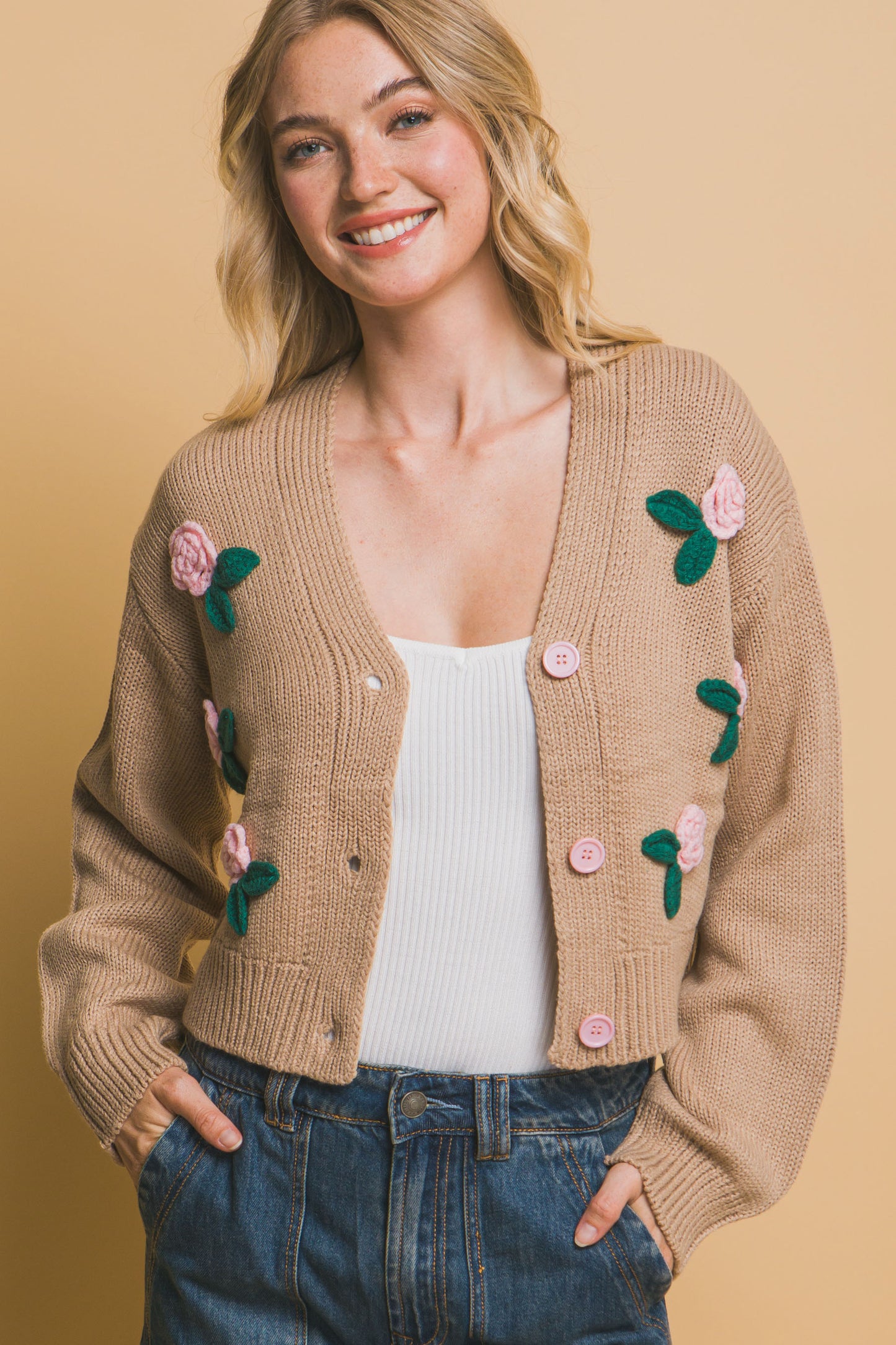 The Liya is a mid-cropped cardigan with charming flower details. Ideal for layering over dresses, blouses, or tees. Perfect for casual outings, work, or social events. Made from 100% acrylic. Colour: Khaki.