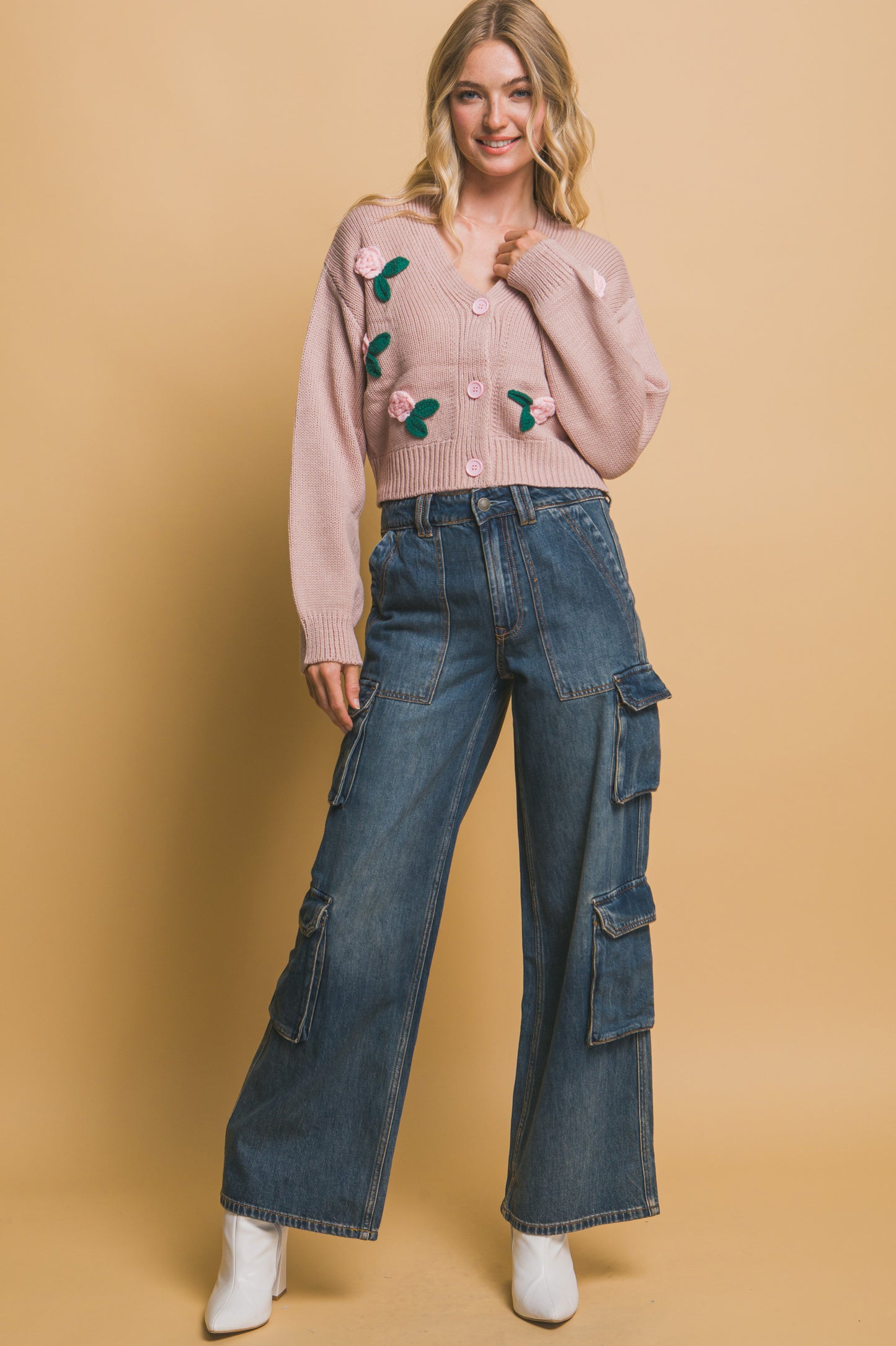 The Liya is a mid-cropped cardigan with charming flower details. Ideal for layering over dresses, blouses, or tees. Perfect for casual outings, work, or social events. Made from 100% acrylic. Colour: Pink Stone.