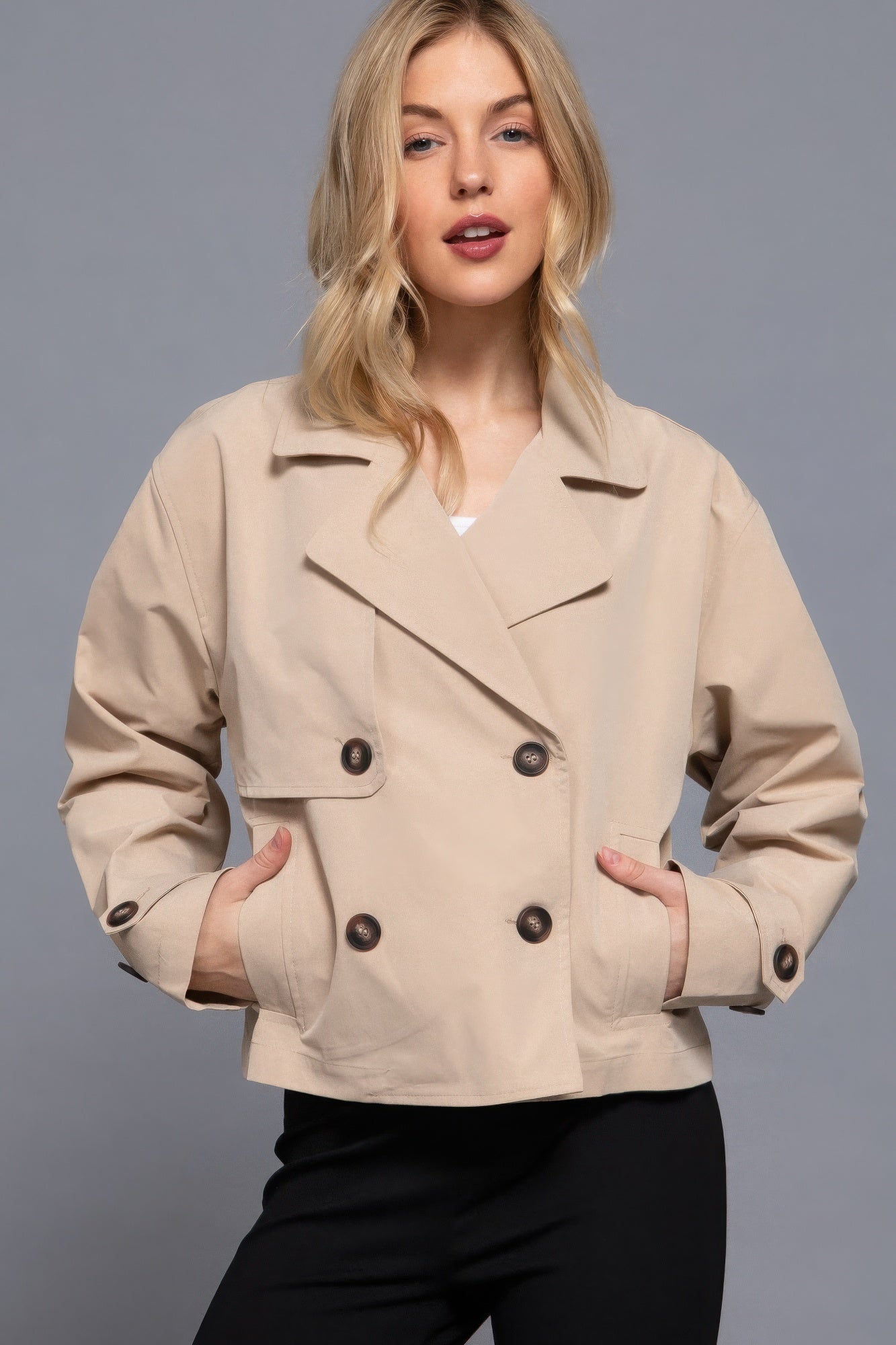 The Julia is our double breasted short trench jacket, a stylish choice for both casual and formal occasions. Each jacket is expertly stitched to ensure durability and a quality finish. Perfect for layering over dresses or tailored outfits, this jacket can seamlessly transition from day to night. Fabric: 100% polyester. Colour: beige.