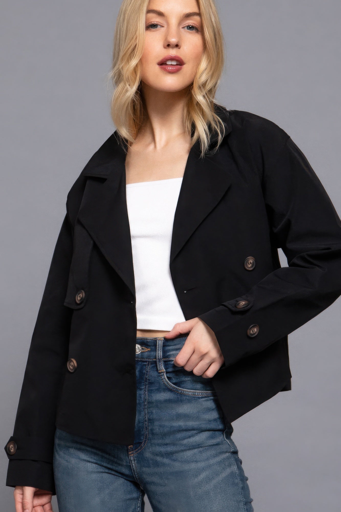 The Julia is our double breasted short trench jacket, a stylish choice for both casual and formal occasions. Each jacket is expertly stitched to ensure durability and a quality finish. Perfect for layering over dresses or tailored outfits, this jacket can seamlessly transition from day to night. Fabric: 100% polyester. Colour: black.