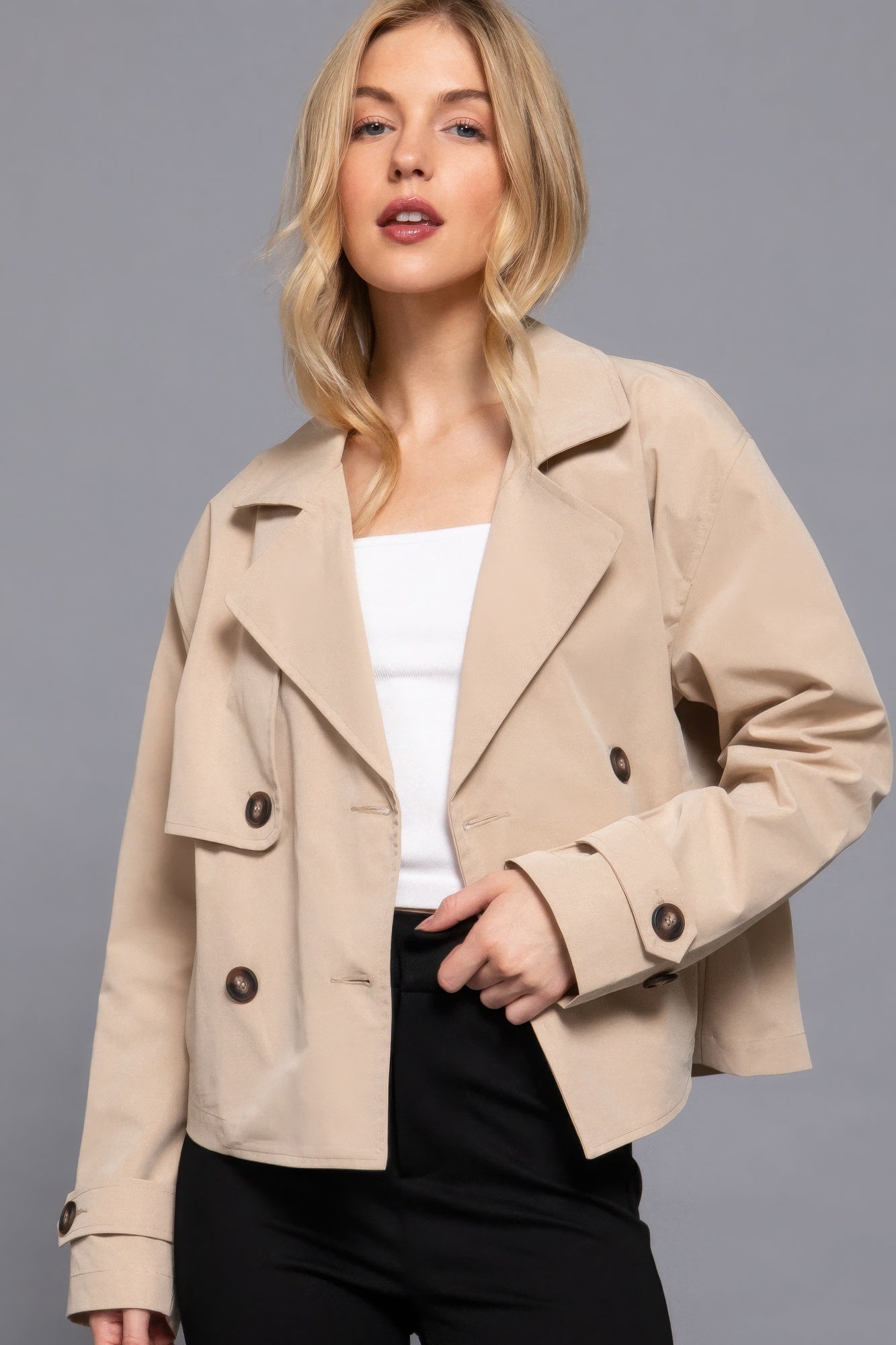 The Julia is our double breasted short trench jacket, a stylish choice for both casual and formal occasions. Each jacket is expertly stitched to ensure durability and a quality finish. Perfect for layering over dresses or tailored outfits, this jacket can seamlessly transition from day to night. Fabric: 100% polyester. Colour: beige.