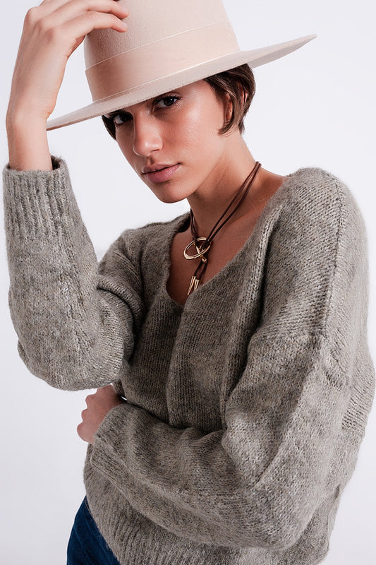 The Khaki Karma is a casual soft knit fluffy sweater with a V-neck, long sleeves and ribbed trims.