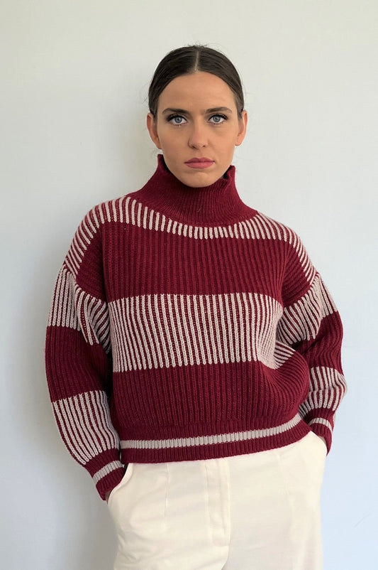 This soft-touch textured jumper is made of Merino Wool for extra comfort, warmth and coziness. It is designed with extra room around the chest for better movement and a high neck that gives it a classy touch. The colour is red and white.